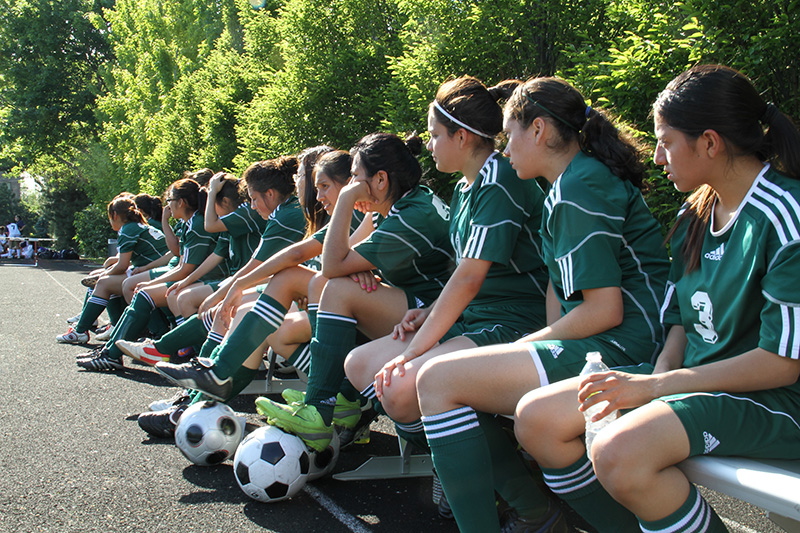 In The Game - Girls Team Sitting On Bench